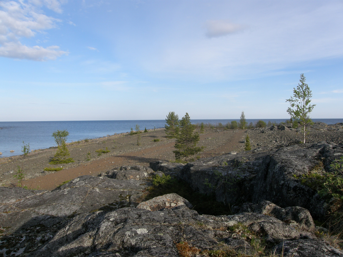 Utsikt från en stenig höjd på Kluntarna, över havet och ett klapperstensfält.